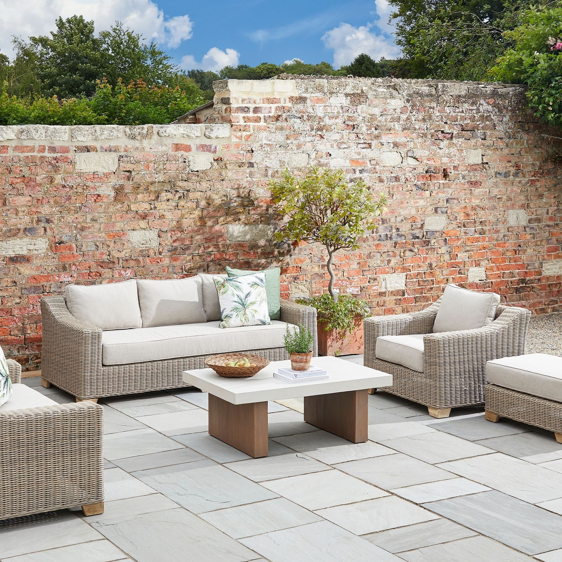 Chunky Rattan-Style Armchair with Plush Cushions & Subtle Metal Detailing